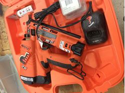 Picture of Paslode nail gun with battery case manual used.tested. 842605-2 