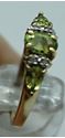 Picture of 10KT YELLOW GOLD RING WITH  4 DIAMONDS 0.02PTS AND 3 PERIDOTS  (1 OVAL; 2 PEAR SHAPE).1.8GR SIZE 7.25 VERY GOOD CONDITION. PRE OWNED.