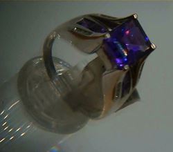 Picture of 14kt white gold ring 6.9 grams total weight . Pre owned. Great condition . With 16 small round diamonds , 8 small princess cut amethysts and centered princess cut amethyst stone.  845441-2 