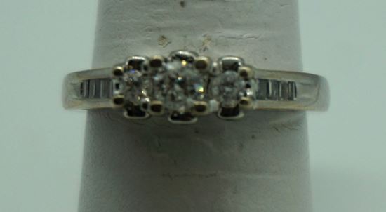 Picture of Engagement ring white gold 14kt with diamonds ( main stone 0.18carat ) mint . Size 7 .Total weight 4.7 gr 17 diamonds - 8 baguette diamonds. 3 round diamonds on top. 6 small Round diamonds on a side.  good condition. 832751-1. 