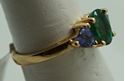 Picture of 14kt yellow gold ring with emerald and tanzanites . Size 6.5 . Total weight 3.3gr. very good condition. Pre owned. Oval emerald and 2 tanzanites . 845374-2. 