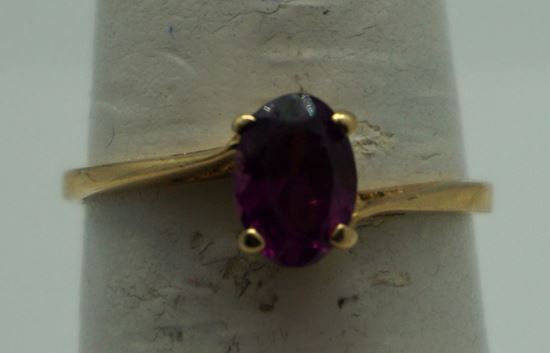 Picture of 14kt yellow gold ring with oval purple stone 1.5gr. pre owned very good condition size 5.75 very good condition. 809422-1. 