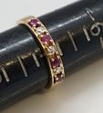 Picture of 14KT YELLOW GOLD FASHION RING 1.8GR SIZE 7 WITH 4 ROUND RED STONES  AND 1 SMALL ROUND DIAMOND IN A CENTER. PRE OWNED. 841354-1. 