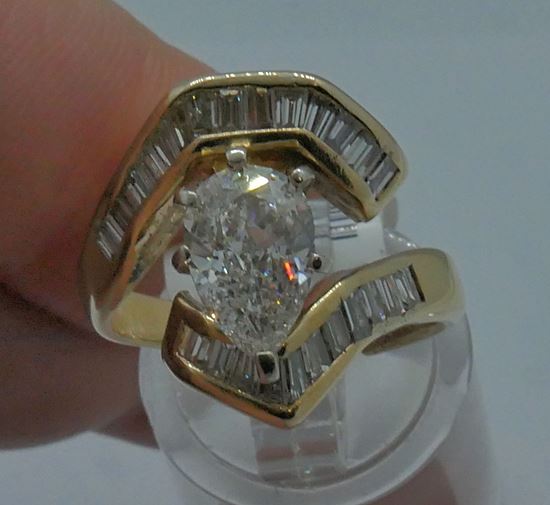 Picture of 14kt yellow gold ring w center pear shape diamond 1.70 carats G color; VVS1 clarity; baguette diamonds 0.85 carats VS2-SI1 H-I color . total carat weight 2.55 carats; 7.9 grams. EDL certified. 827412-1